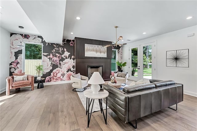 living room with light hardwood / wood-style flooring and french doors