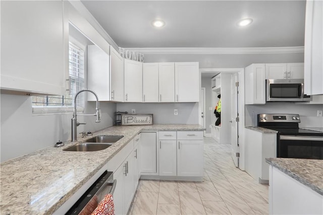 kitchen featuring ornamental molding, a sink, appliances with stainless steel finishes, white cabinetry, and marble finish floor