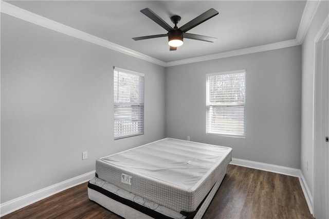 bedroom featuring ceiling fan, crown molding, baseboards, and wood finished floors