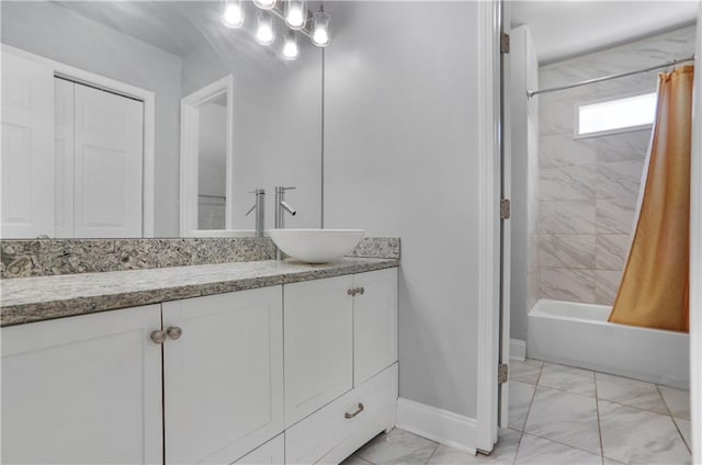 bathroom featuring marble finish floor, vanity, baseboards, and shower / bathtub combination with curtain