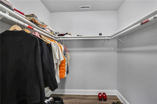 walk in closet featuring visible vents and wood finished floors