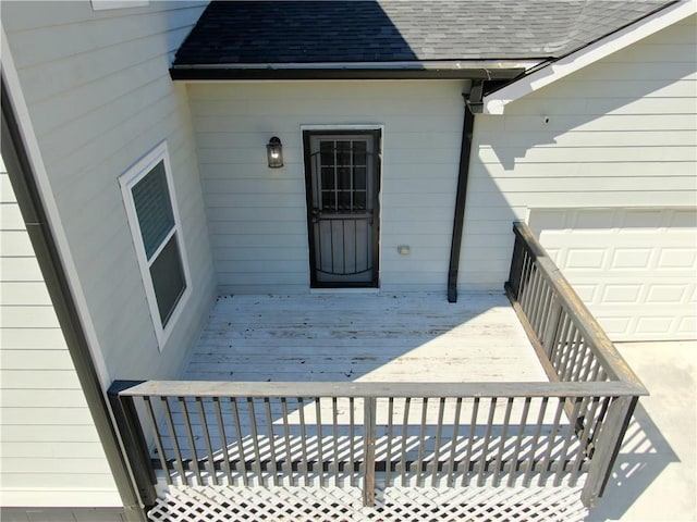 wooden terrace featuring an attached garage