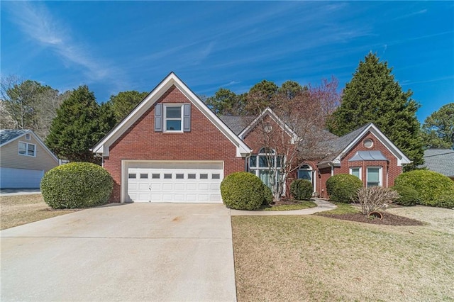 traditional-style home featuring brick siding, an attached garage, concrete driveway, and a front yard