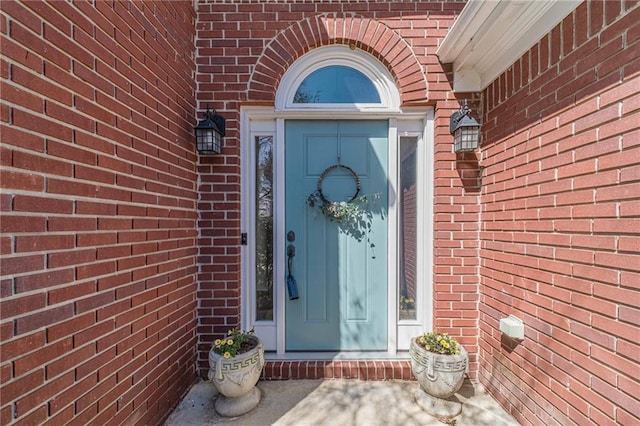 property entrance with brick siding