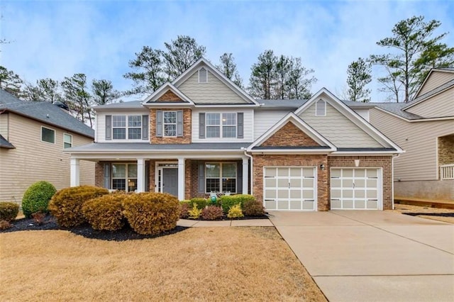 craftsman inspired home featuring a garage and covered porch