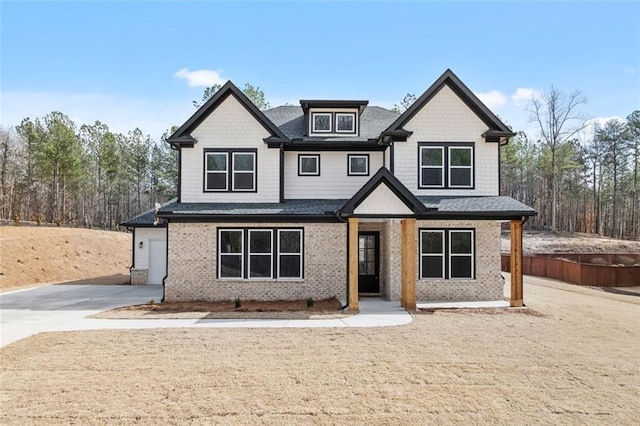 craftsman-style home with concrete driveway and brick siding