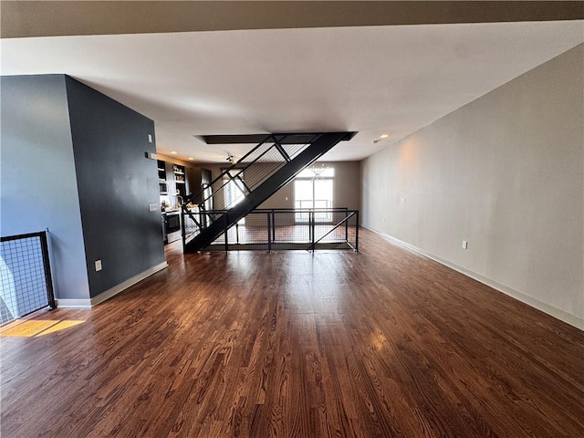 1400 Peter Haughton Way NW, Atlanta, GA 30318 - unfurnished living room featuring baseboards and wood finished floors