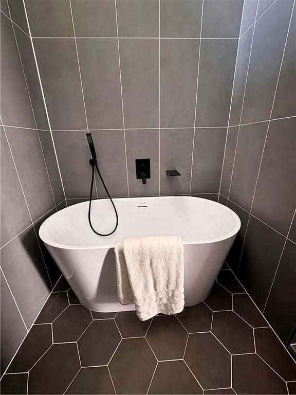 1400 Peter Haughton Way NW, Atlanta, GA 30318 - bathroom with tile walls, tile patterned flooring, and a freestanding bath