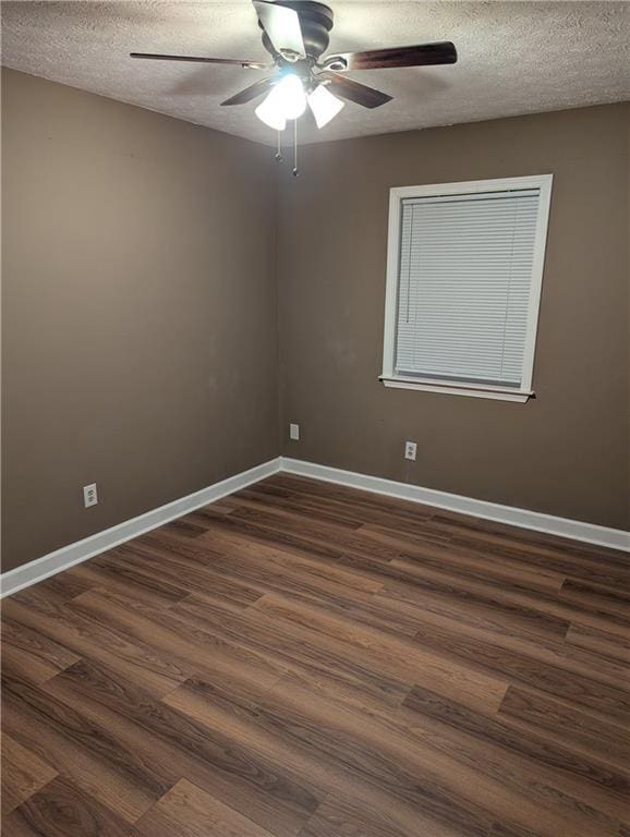 unfurnished room featuring dark hardwood / wood-style flooring, ceiling fan, and a textured ceiling