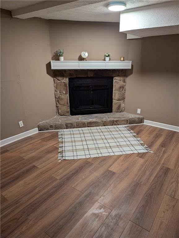 interior details with wood-type flooring, a textured ceiling, and a fireplace