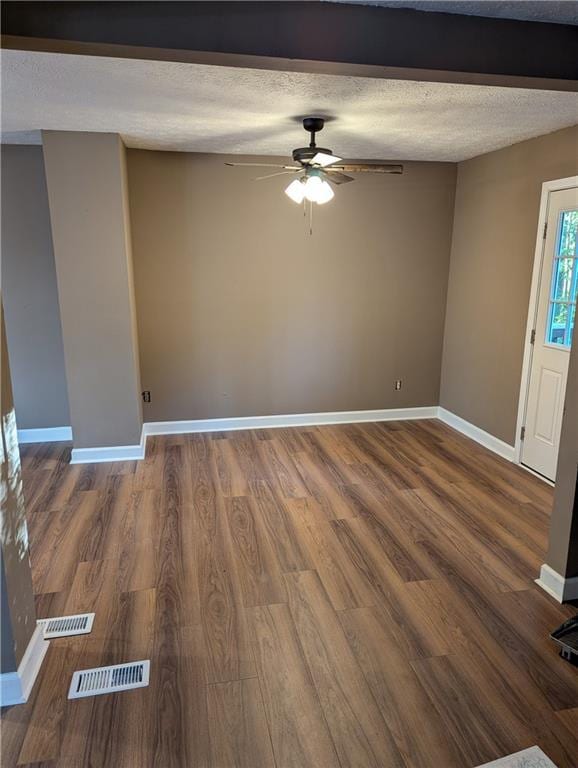 unfurnished room featuring ceiling fan, wood-type flooring, and a textured ceiling