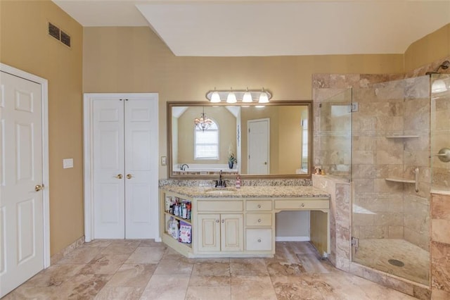 bathroom with vanity and a shower with shower door