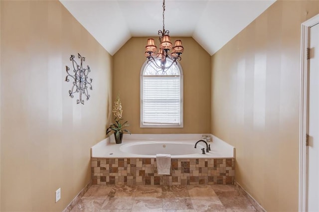 bathroom featuring vaulted ceiling and a relaxing tiled tub