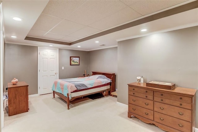 carpeted bedroom featuring crown molding and a tray ceiling