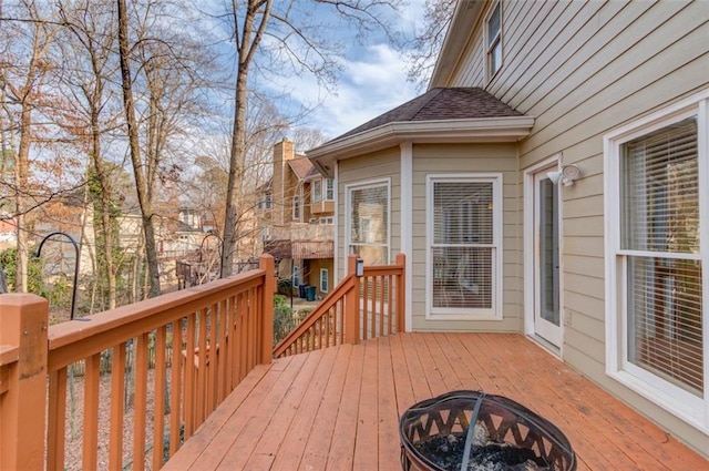 wooden terrace featuring a fire pit