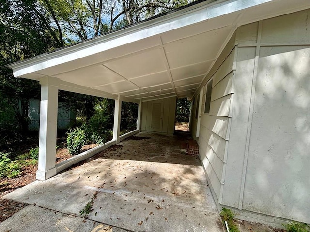 exterior space featuring a shed and a carport