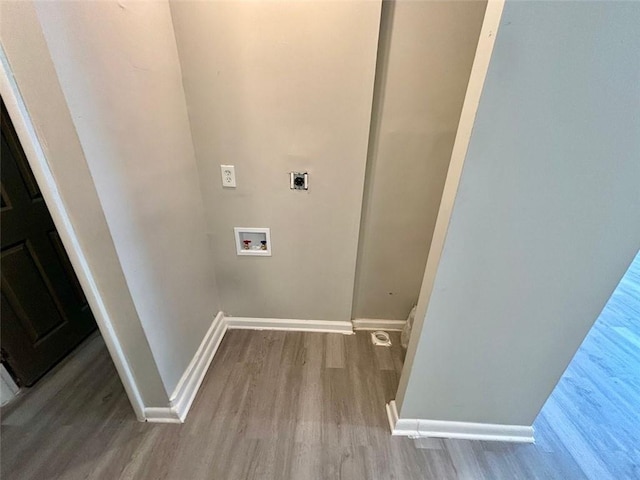 washroom with light hardwood / wood-style flooring, washer hookup, and electric dryer hookup