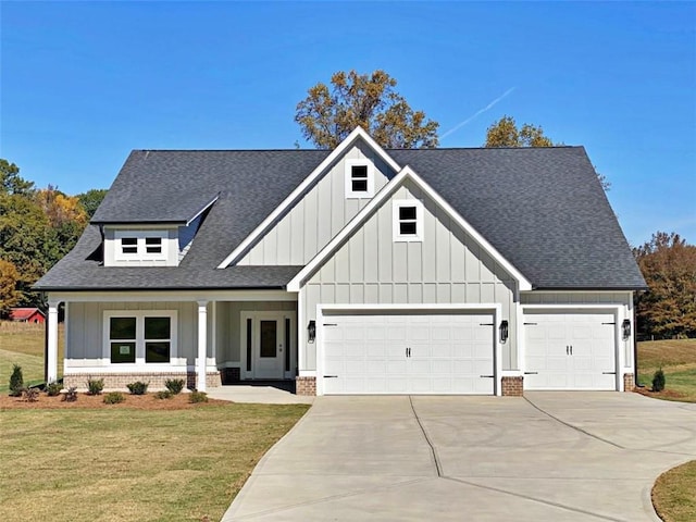 view of front of home with a front yard and a garage