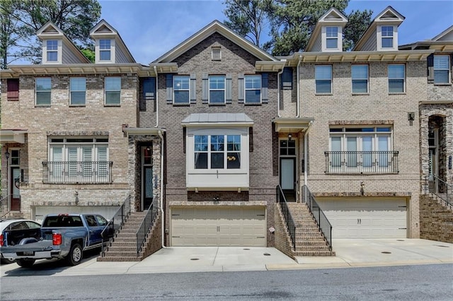 multi unit property featuring stairs and an attached garage