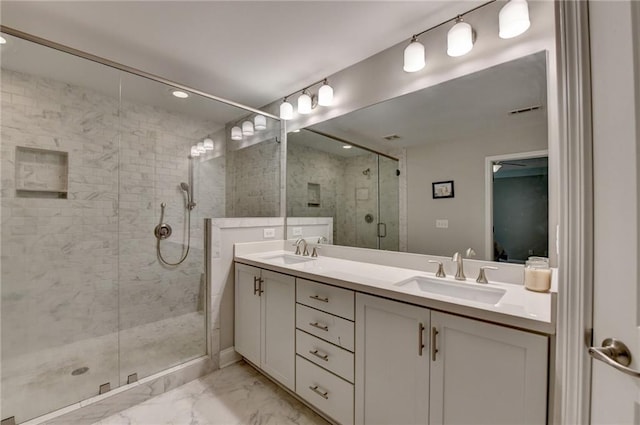 bathroom featuring marble look tile flooring, a shower stall, and double vanity