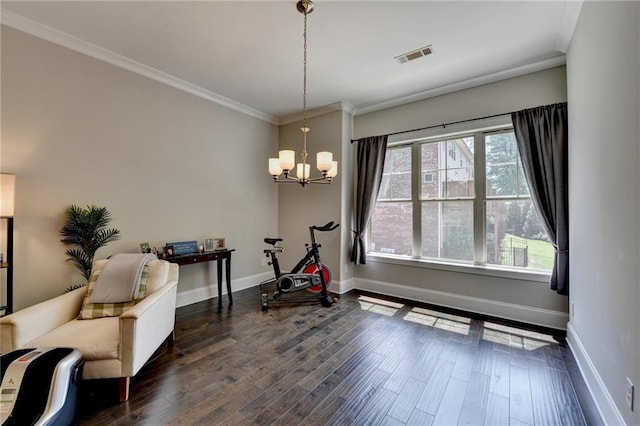 sitting room with a chandelier, ornamental molding, baseboards, and dark wood finished floors