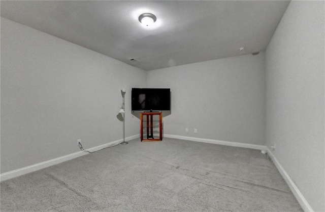 carpeted empty room featuring baseboards