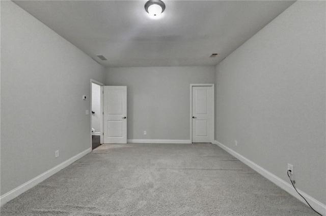 empty room with carpet floors and baseboards