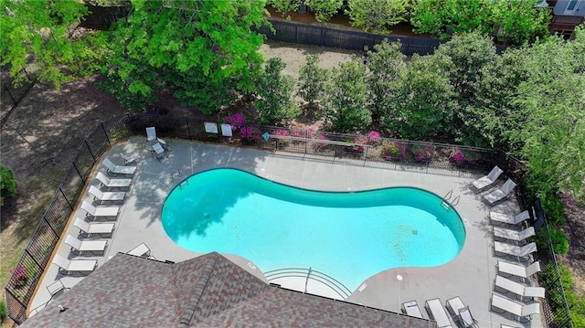community pool featuring fence and a patio area
