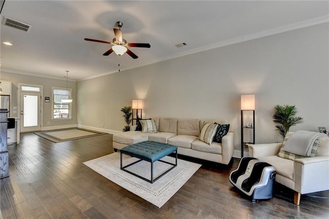 living area featuring ornamental molding, ceiling fan, dark wood-style floors, and baseboards