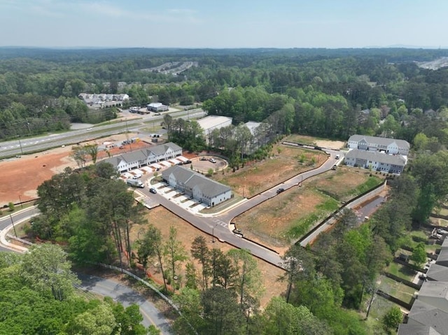 birds eye view of property featuring a wooded view
