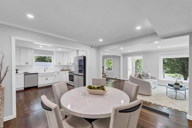 dining space featuring visible vents, dark wood finished floors, stairs, ornamental molding, and recessed lighting