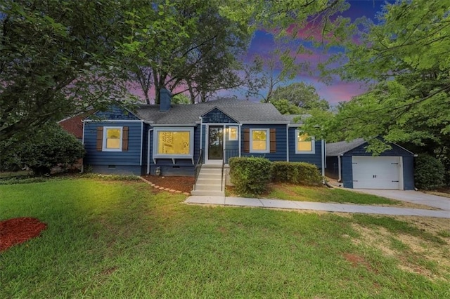 bungalow with a front yard, an outbuilding, a detached garage, and crawl space