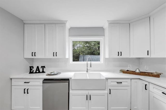 kitchen featuring light countertops, white cabinets, dishwashing machine, and a sink