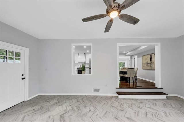 entryway featuring a ceiling fan, visible vents, and baseboards