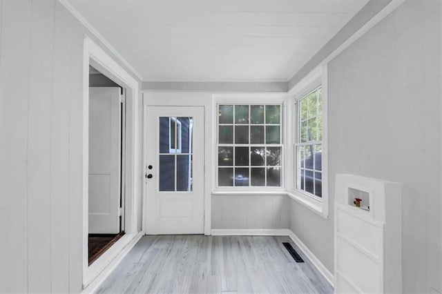 unfurnished sunroom featuring visible vents