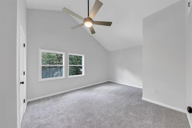 empty room featuring carpet flooring, a ceiling fan, baseboards, and high vaulted ceiling