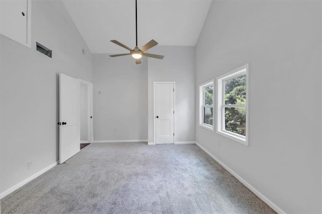 unfurnished bedroom with baseboards, carpet floors, high vaulted ceiling, and ceiling fan