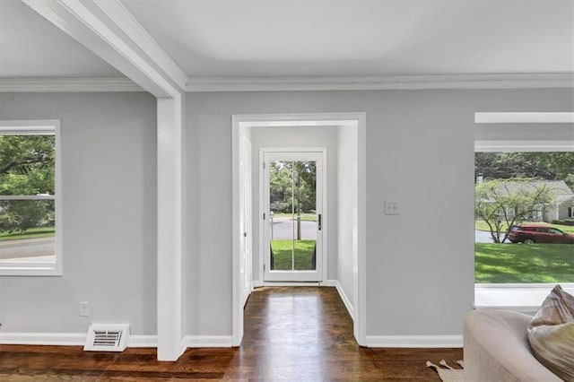 foyer featuring crown molding, baseboards, visible vents, and dark wood-type flooring