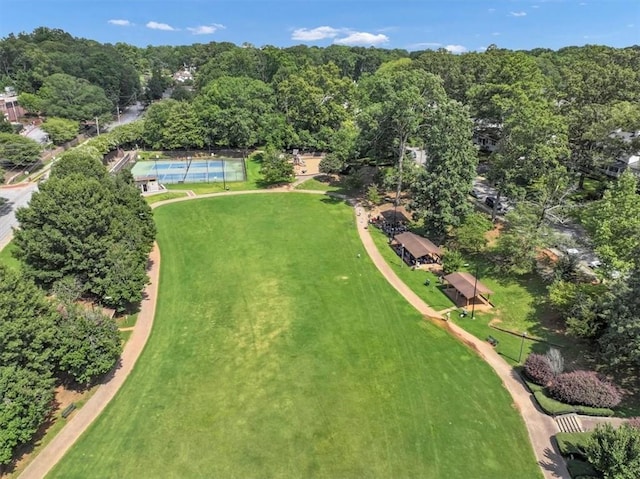 drone / aerial view with a wooded view