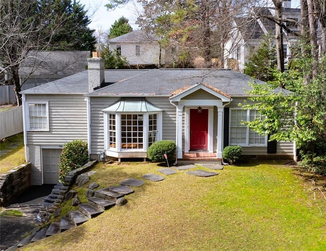 single story home with a garage, entry steps, a chimney, and a front yard