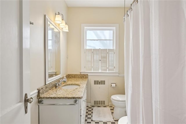full bath featuring toilet, vanity, and radiator heating unit