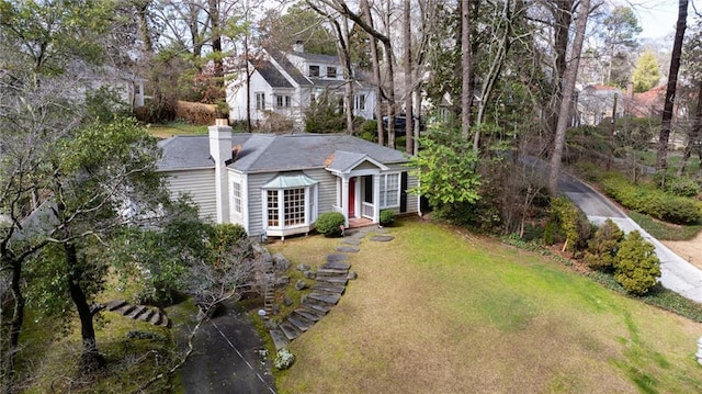 exterior space featuring a chimney and a front lawn