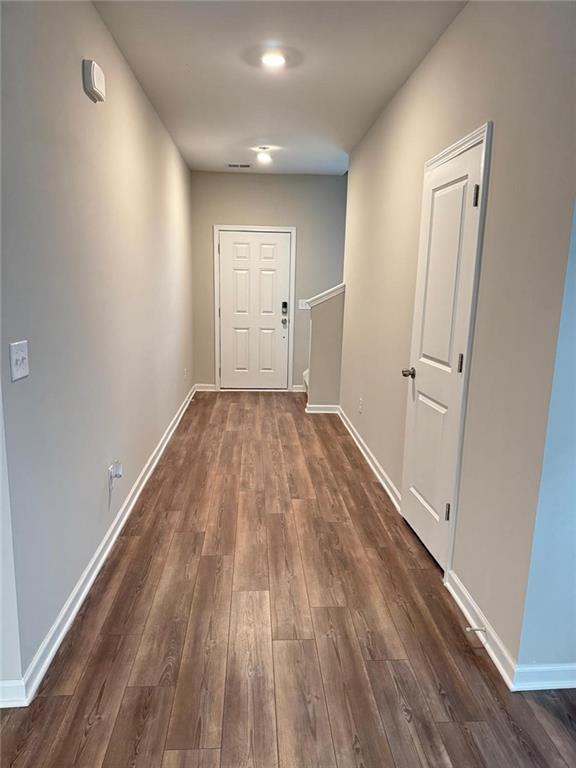 hall with dark hardwood / wood-style flooring