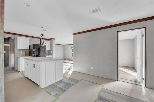 2655 Jess Guest Rd, Dewy Rose, GA 30634 - kitchen with black refrigerator with ice dispenser, white cabinetry, a kitchen island, light countertops, and decorative light fixtures