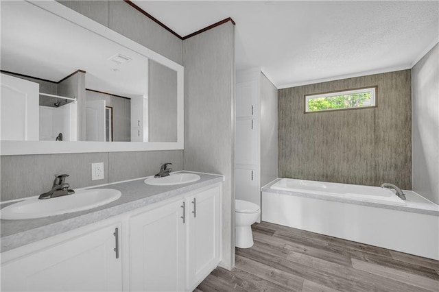 2655 Jess Guest Rd, Dewy Rose, GA 30634 - bathroom featuring toilet, a bath, double vanity, wood finished floors, and a textured ceiling