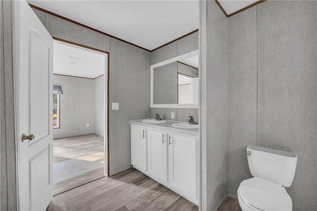 2655 Jess Guest Rd, Dewy Rose, GA 30634 - bathroom featuring wood finished floors, double vanity, ornamental molding, and toilet