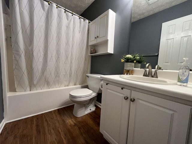 2529 Feathertree Ln, Lawrenceville, GA 30044 - full bathroom featuring a textured ceiling, toilet, vanity, wood finished floors, and shower / bath combination with curtain
