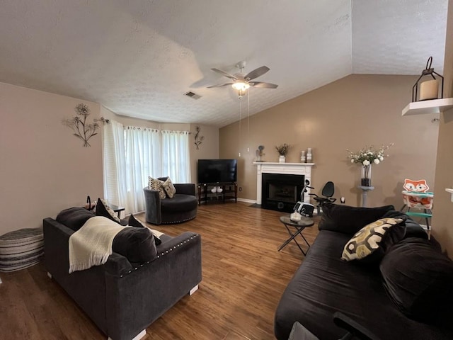 2529 Feathertree Ln, Lawrenceville, GA 30044 - living room with a ceiling fan, wood finished floors, a textured ceiling, lofted ceiling, and a fireplace with flush hearth