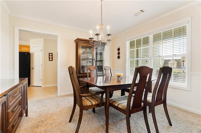 dining area featuring crown molding, light carpet, and an inviting chandelier