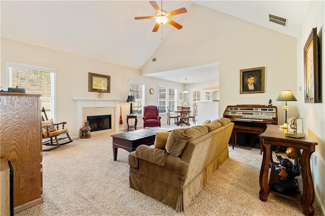 living room featuring light carpet, high vaulted ceiling, and ceiling fan